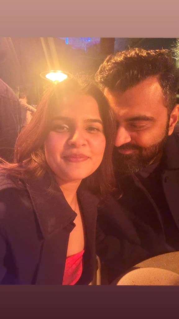 Charu and Alok together on a warm-lit evening out